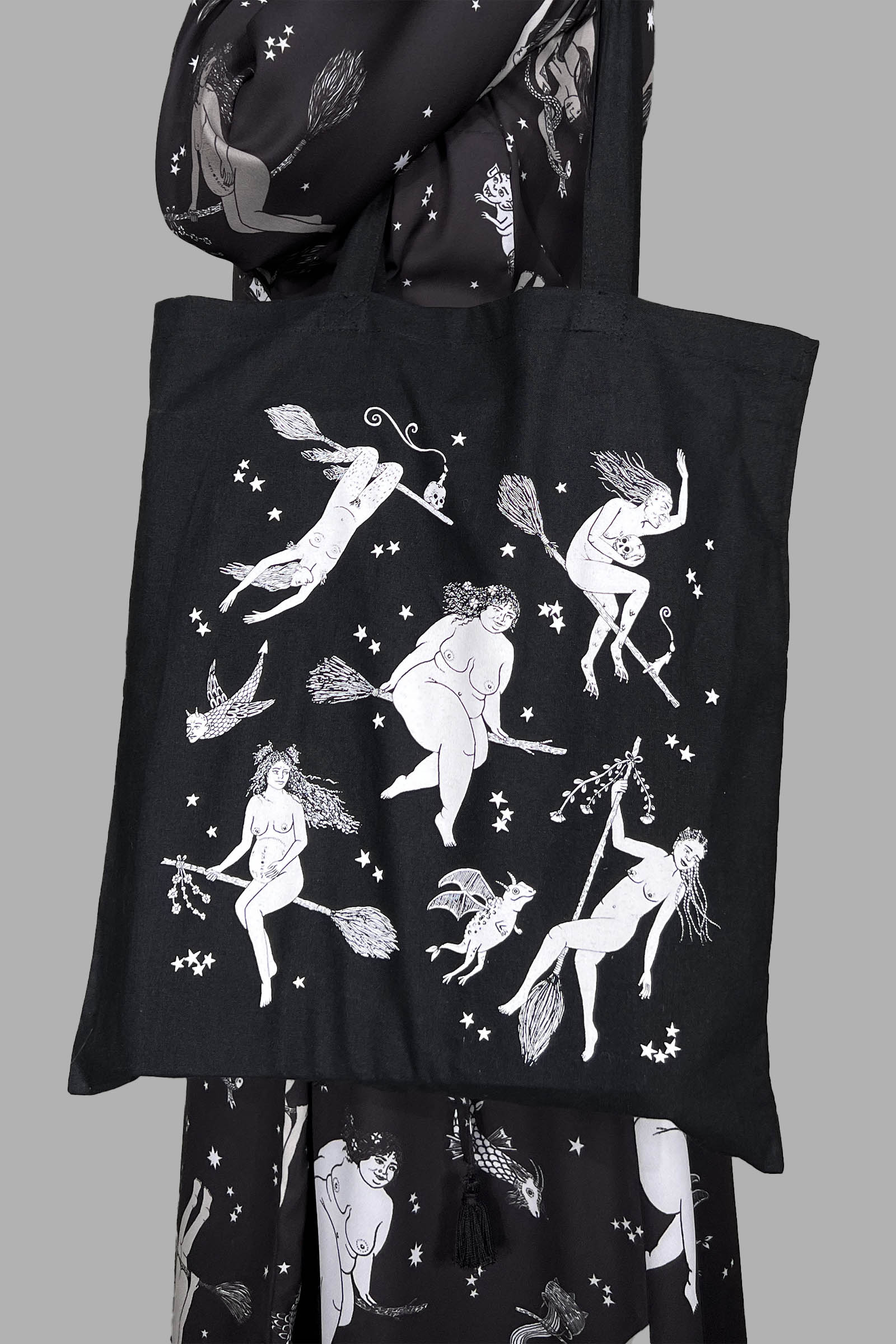 Black tote bag with a white witchy print.